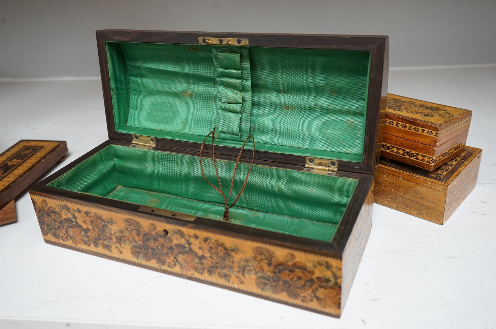 Three Tunbridge Ware boxes to include a glove box, another housing a set of miniature playing cards and a cribbage board, 24cm. Condition - fair